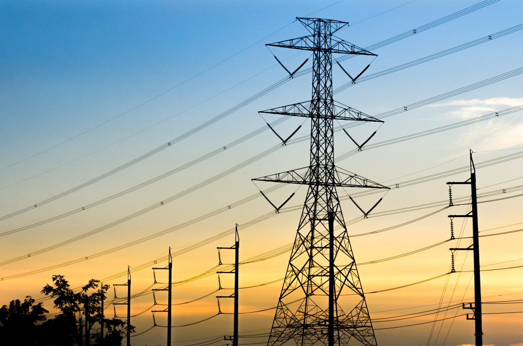 High voltage Electrical Transmission Towers With Sunset Backgrou 